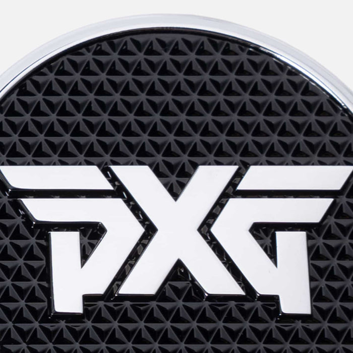 PXG chrome golf ball marker with a black leather encasing and a white pxg logo on a white background