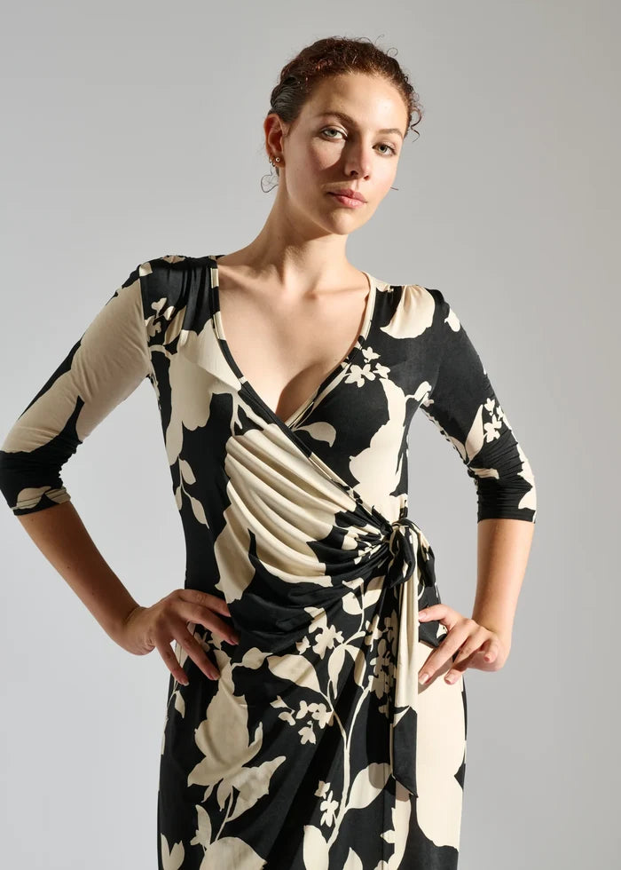 Woman wearing black and cream floral dress