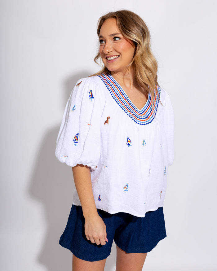 White puff sleeve top with blue and red sailboat embroidery, coastal nautical women's blouse at Gaudie & Co