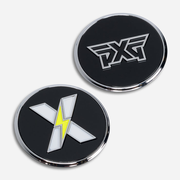 PXG chrome golf ball marker with a black side featuring an "X" with a yellow lightning bolt and a black side featuring a black PXG logo, on a white background