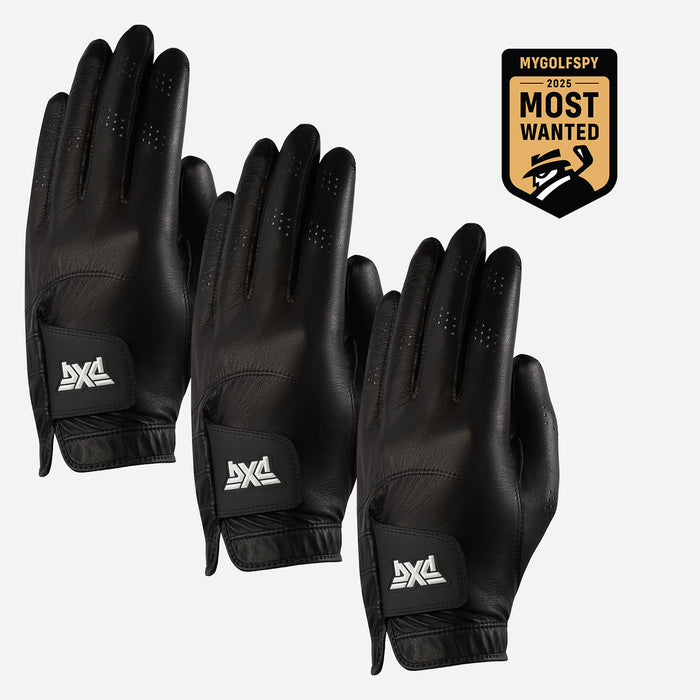 Three black leather golf gloves with white AXA logos on the wrist straps, arranged on a light gray background next to a gold and black 'MyGolfSpy 2023 Most Wanted' badge.