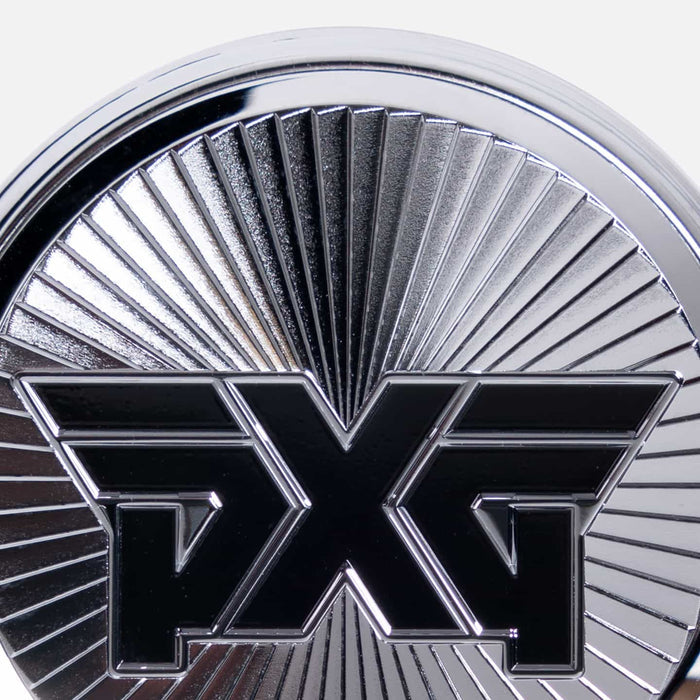 PXG chrome golf ball marker with a black pxg logo on a white background