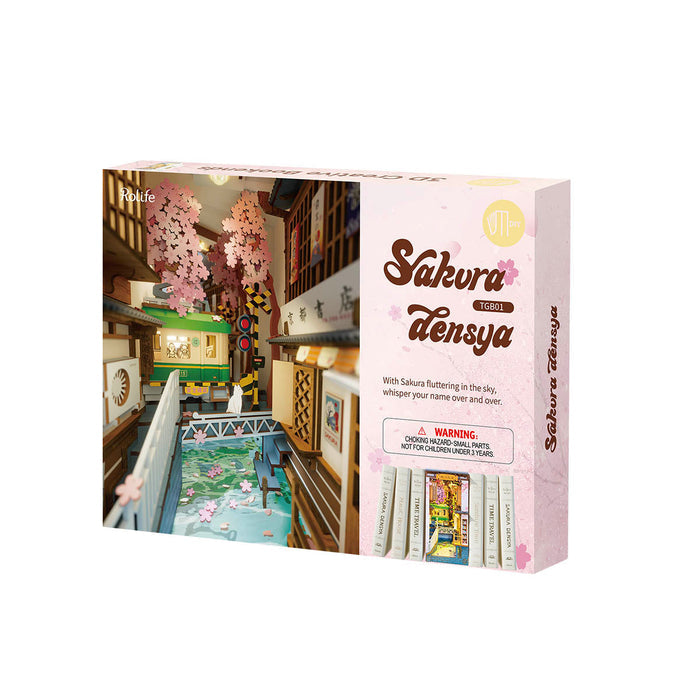 Rolife Sakura Densya TGB01 retail packaging box with illustrated bookshelf cover art in pink and green tones