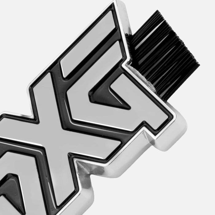 PXG chrome dual-sided wedge golf brush with black brushes on both ends of the PXG logo on a white background