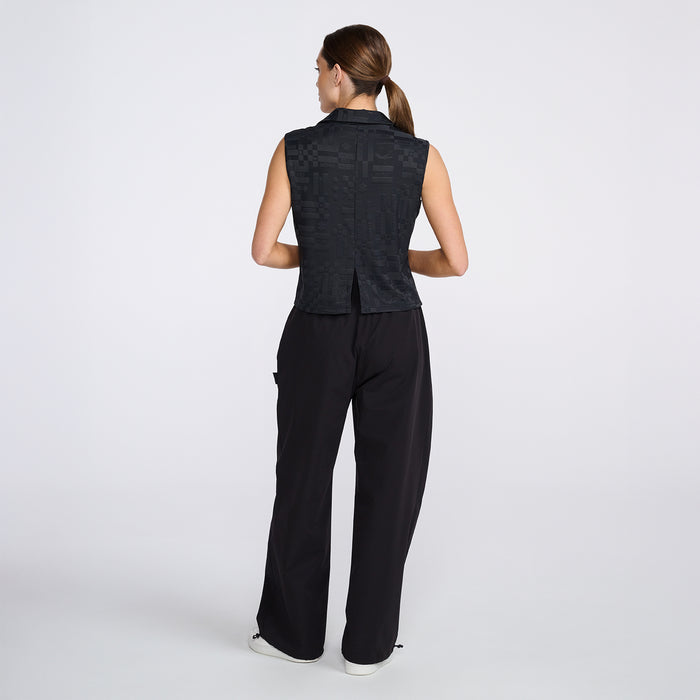 Women's #SheGolfs Sleeveless Polo in Black, back view