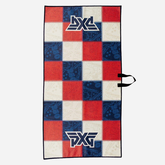 PXG stars and stripes players golf towel with patchwork colors of blue, white, and red on a white background