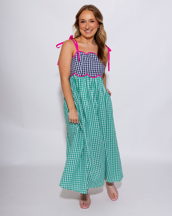 Colorblock gingham midi dress with black gingham bodice, green gingham skirt, and hot pink contrast waist detail, women's boutique dress at Gaudie & Co