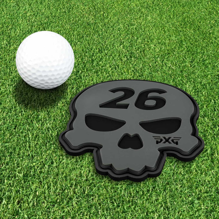PXG white candle that has a black candle holder with pxg as a logo on the side on a white background