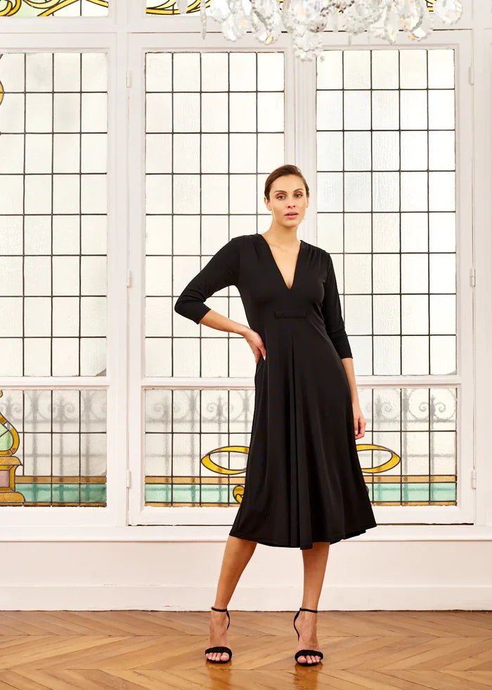 Woman models black V-neck midi dress