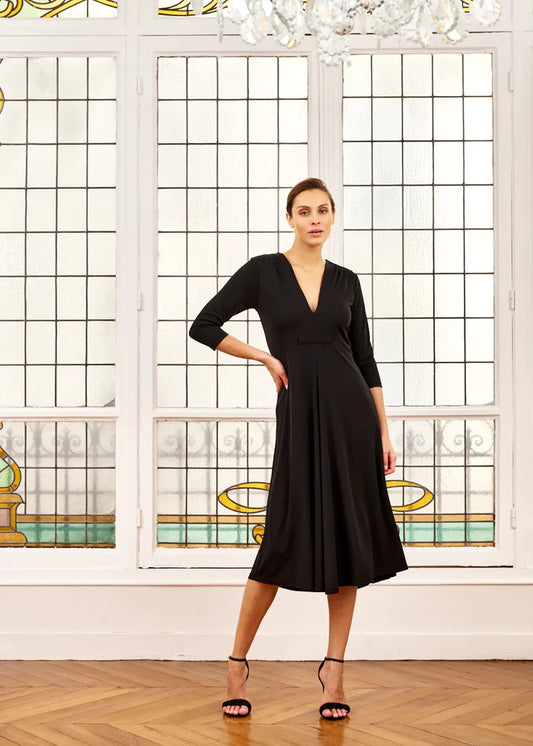 Woman models black V-neck midi dress