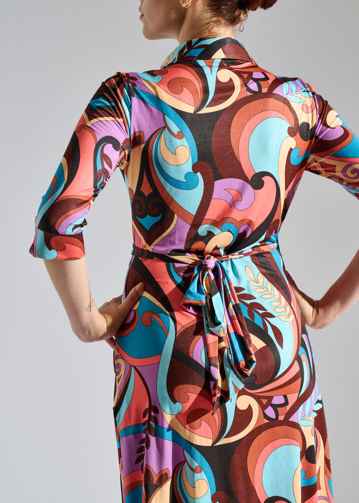 Woman models multicolor knee-length dress
