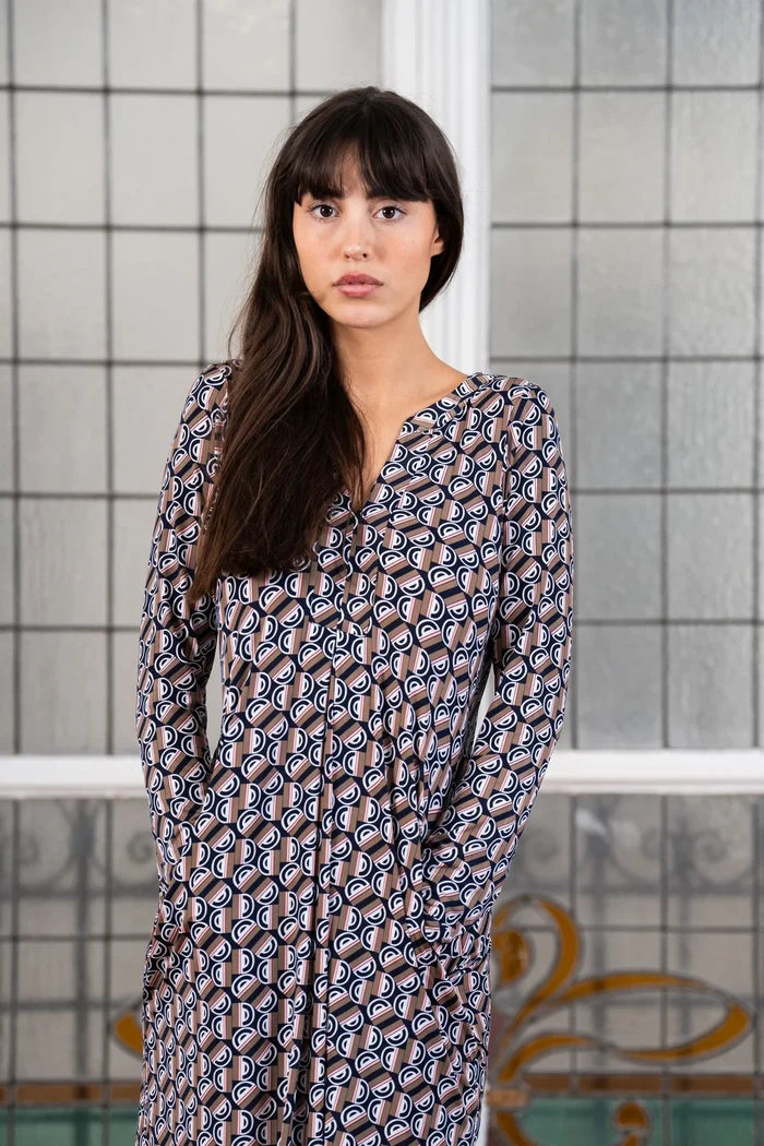 Model in long sleeve knee length dress