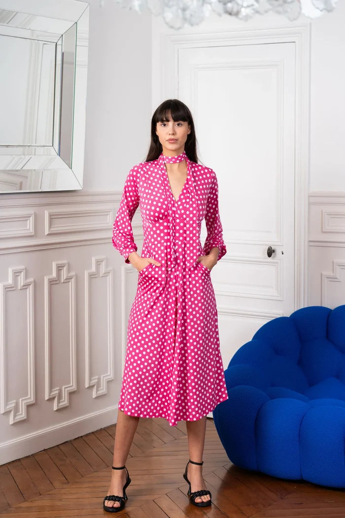 Model wears an Elegance Miss pink and white polka dot dress