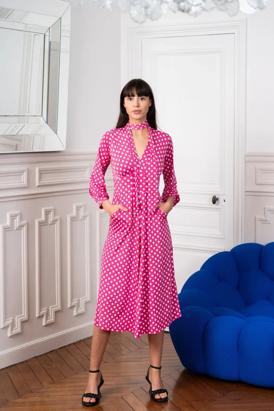Model wears an Elegance Miss pink and white polka dot dress