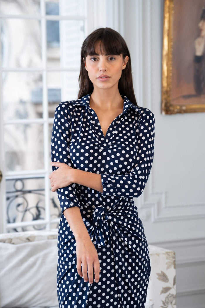 Model wears an Elegance Miss navy blue and white dress