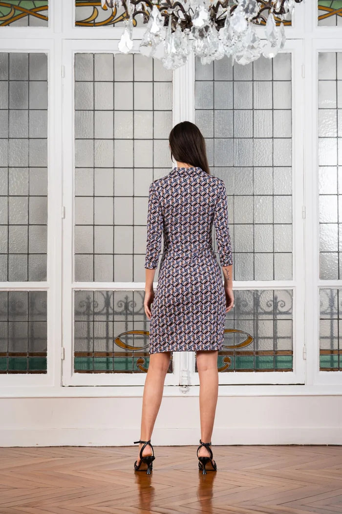 Model poses in a graphic print dress