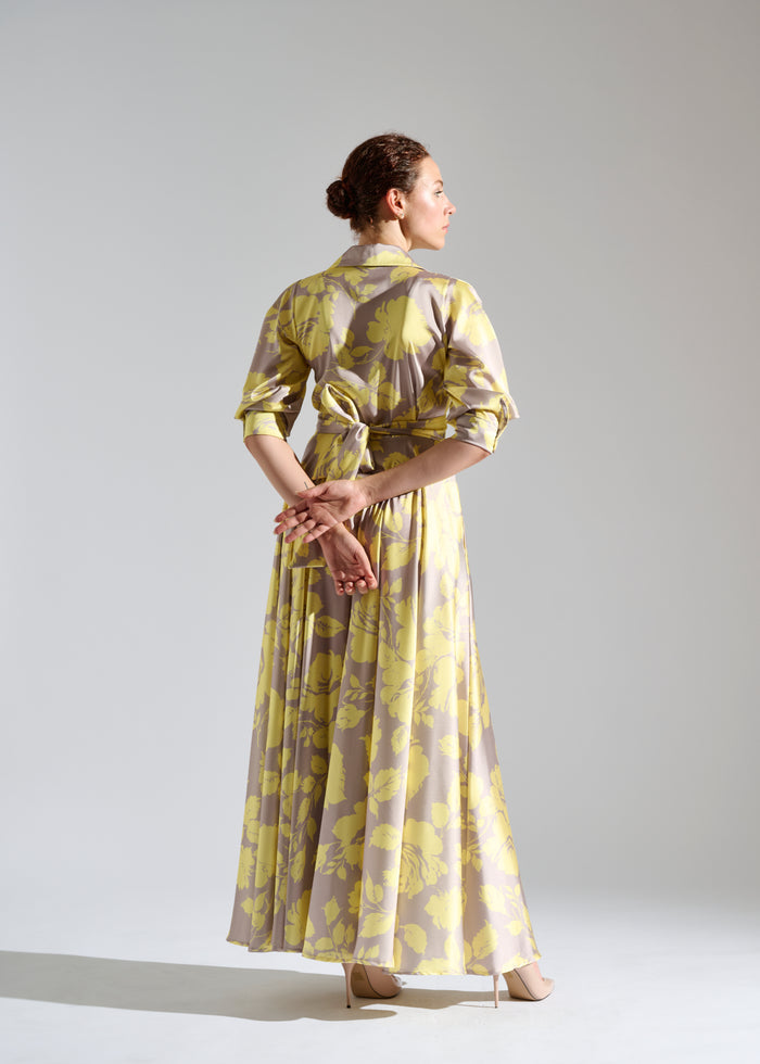 Back view of Kayz pastel maxi dress with white floral pattern.