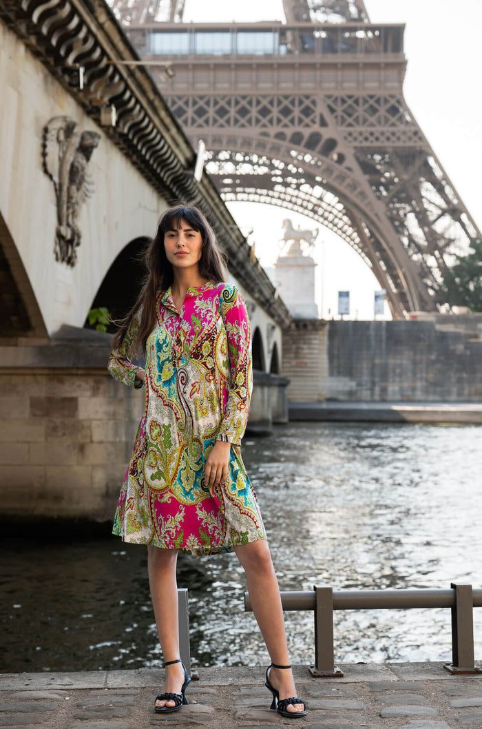 Model poses in paisley printed dress in front of the Eiffel Tower