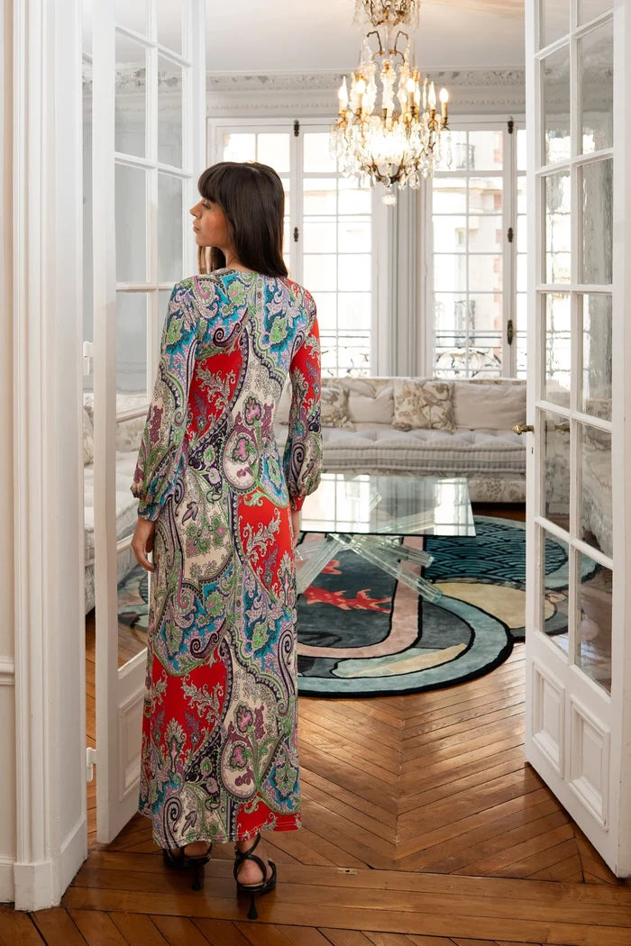 Model dons flowy boho maxi dress with sleeves