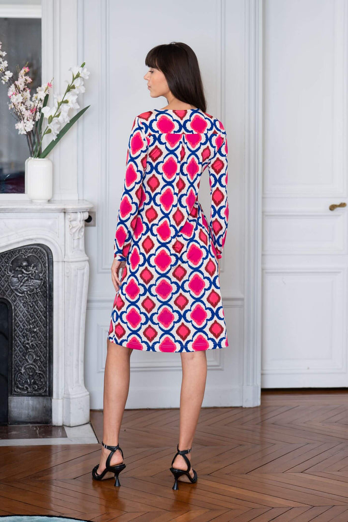Woman wears long-sleeved patterned dress in a Paris apartment