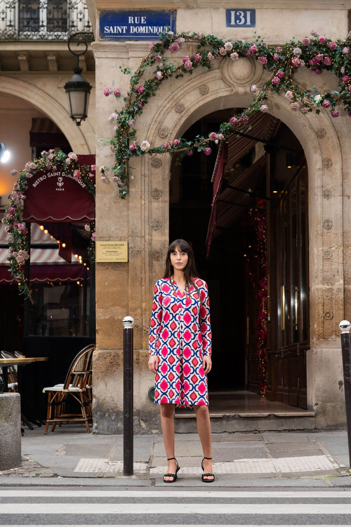 Woman models an Elegance Miss knee length dress with sleeves