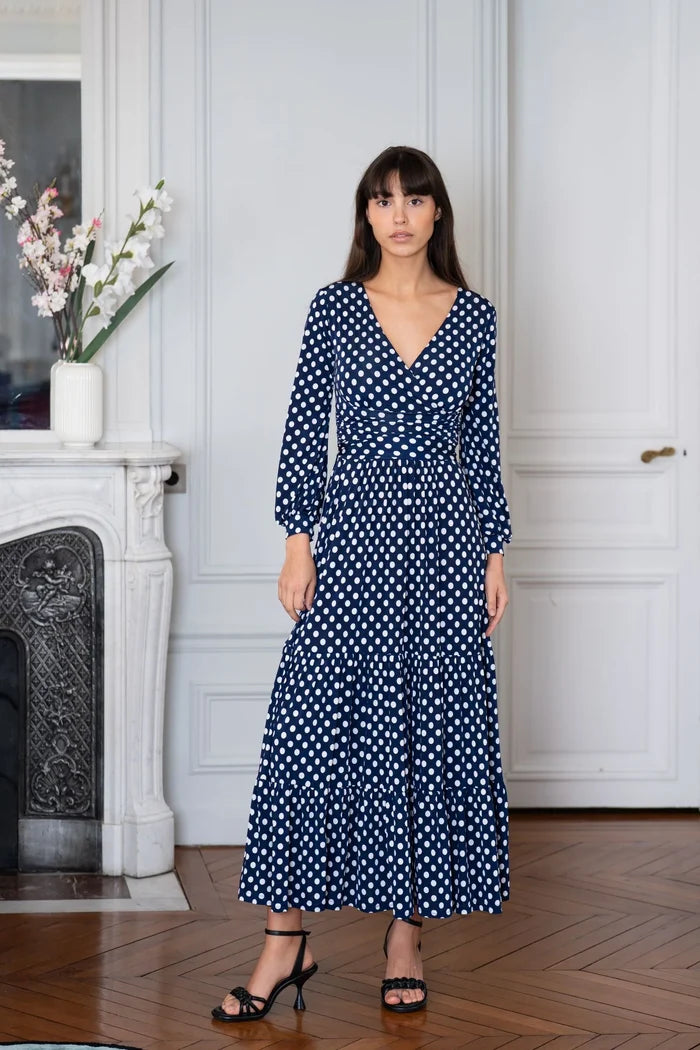 Woman models an Elegance Miss long sleeve polka dot dress