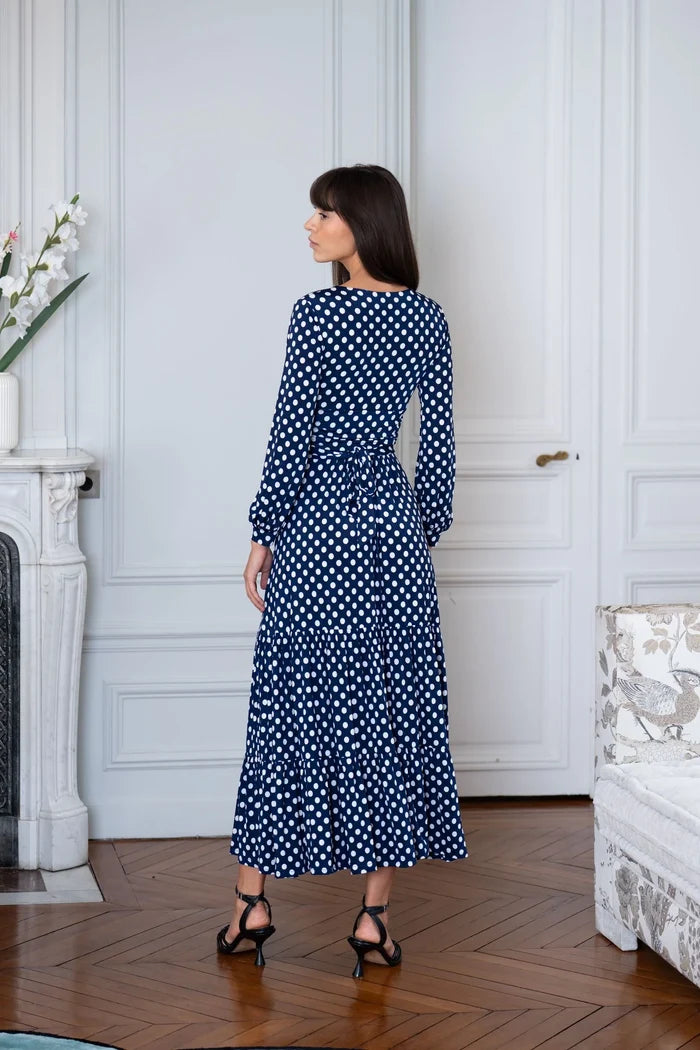 Woman wears navy blue polka dot maxi dress