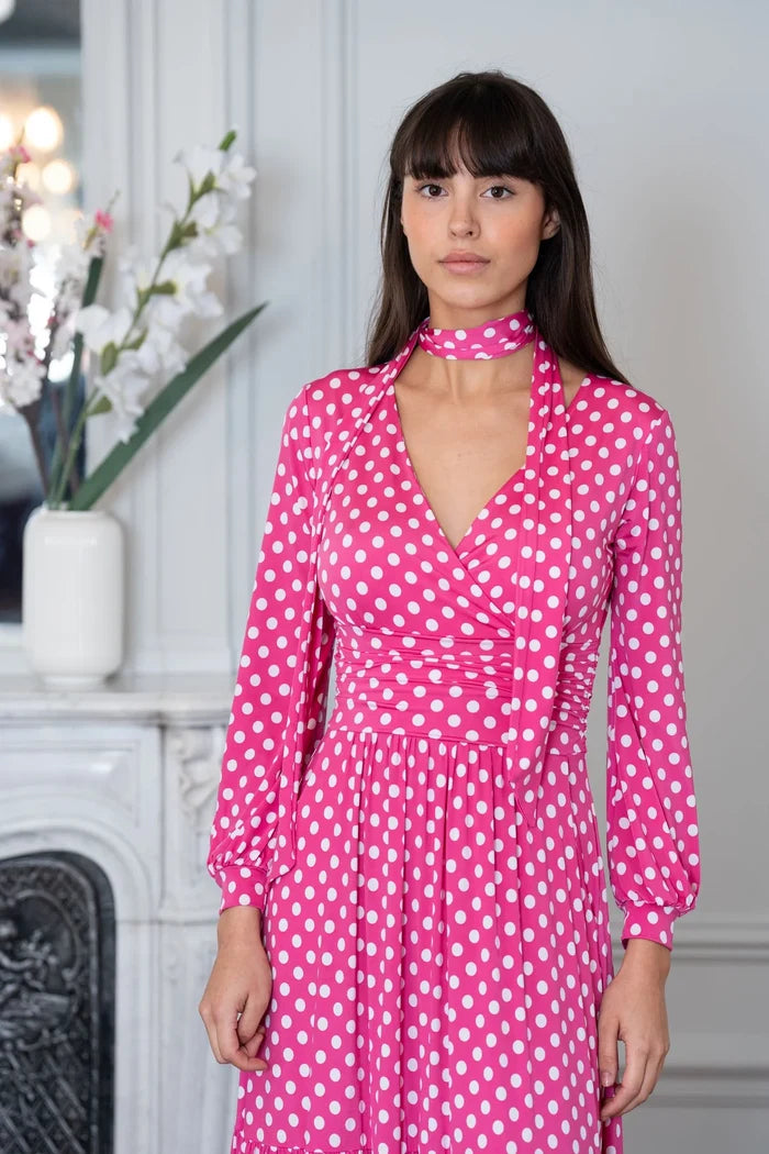 Model wears an Elegance Miss women's pink polka dot dress in a Paris apartment