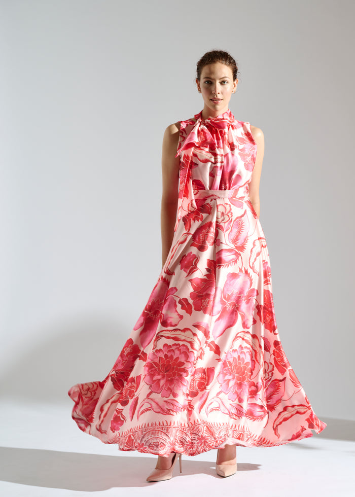 Linda white maxi dress with red floral pattern.