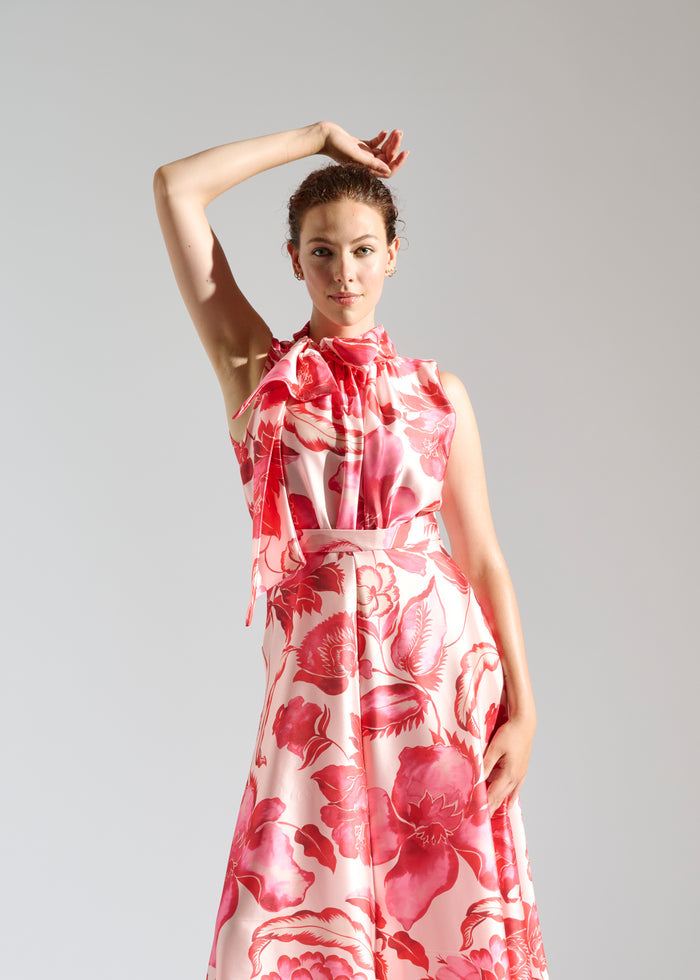 Close up of Linda white maxi dress with red floral pattern.