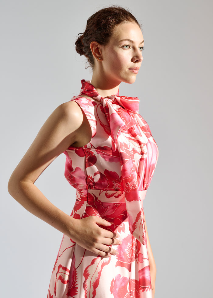 Side view of Linda white maxi dress with red floral pattern.