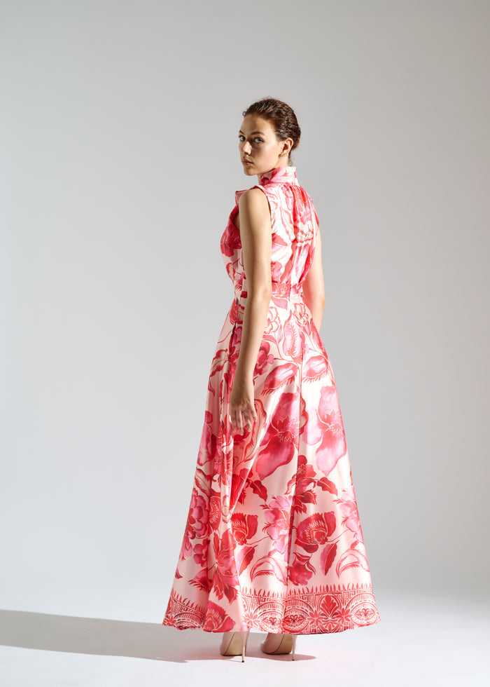 Full view of Linda white maxi dress with red floral pattern.