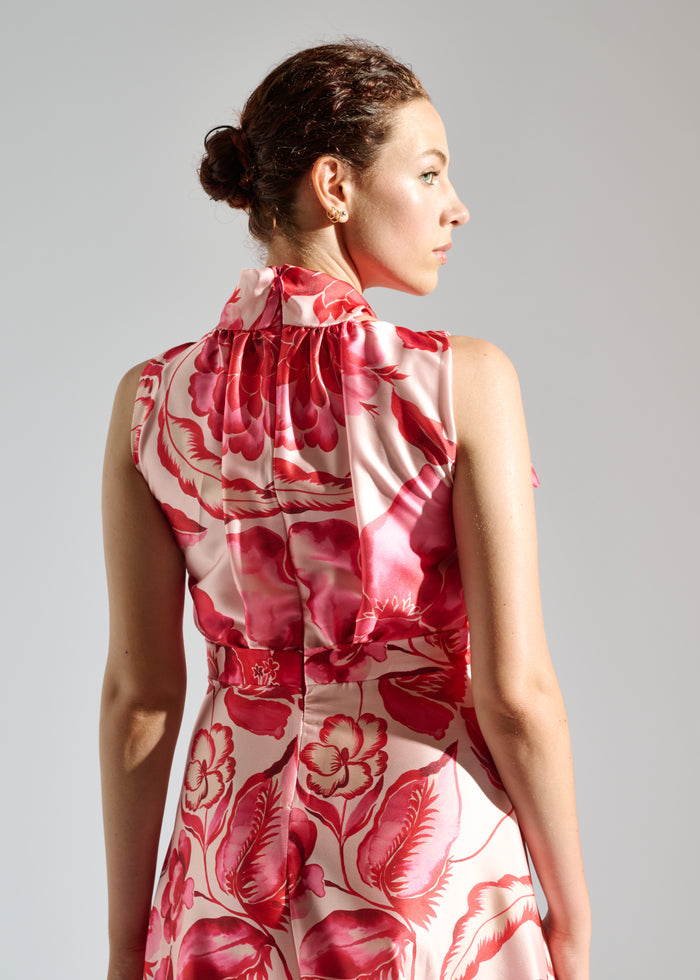 Back view of Linda white maxi dress with red floral pattern.