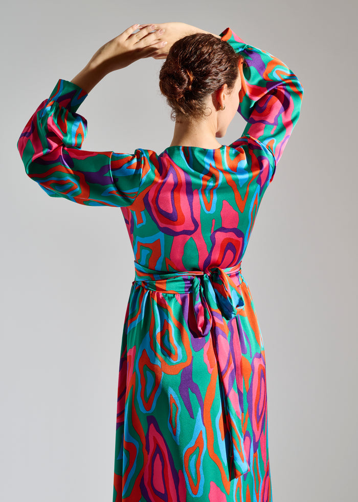 Close up of Lovei abstract-patterned green, red, and purple maxi dress.