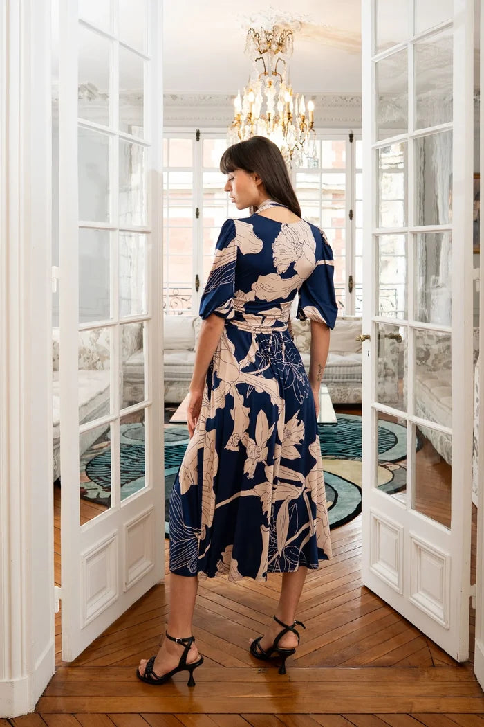 Woman models a blue and beige dress