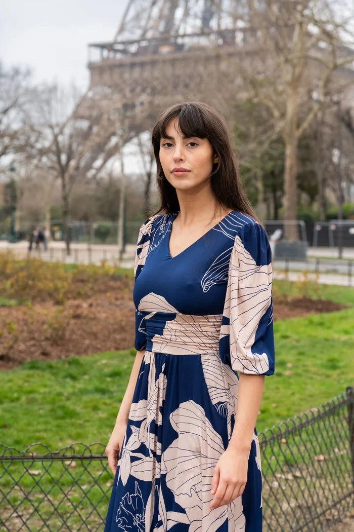 Woman wears a midi dress in front of the Eiffel Tower