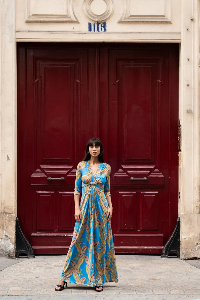 Model wears tropical print maxi dress in Paris