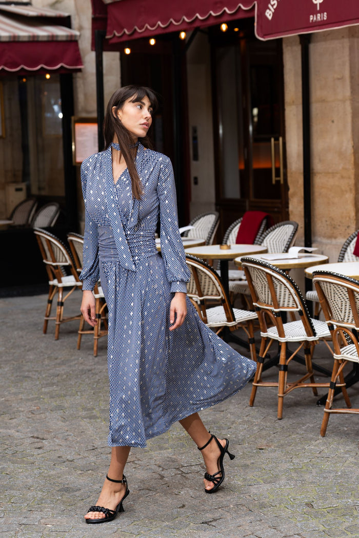 Model walking wearing blue pattern midi dress