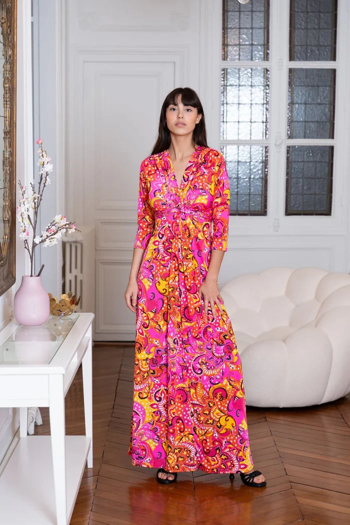 Model wears Elegance Miss women’s pink and orange dress in a Paris apartment