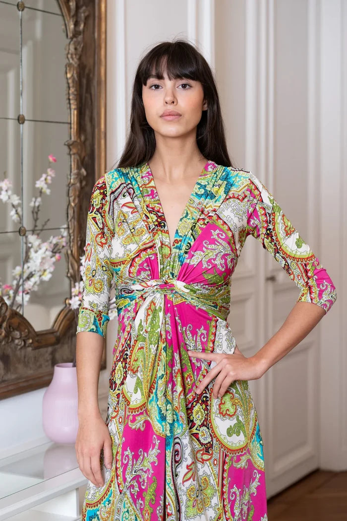 Model poses in a 3/4 sleeve knee length dress in a Paris apartment