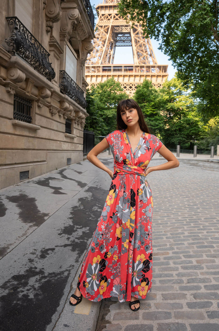 Model wears a floral print wrap dress in front of the Eiffel Tower