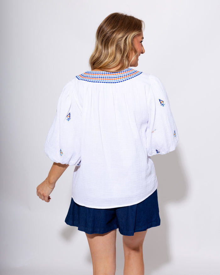 White puff sleeve top with blue and red sailboat embroidery, coastal nautical women's blouse at Gaudie & Co