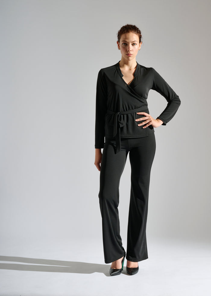 A woman models Elegance Miss black two-piece pants set