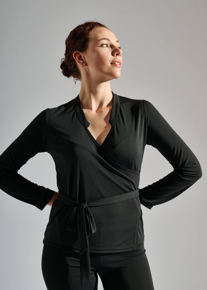 Woman wears Elegance Miss long-sleeve black two-piece