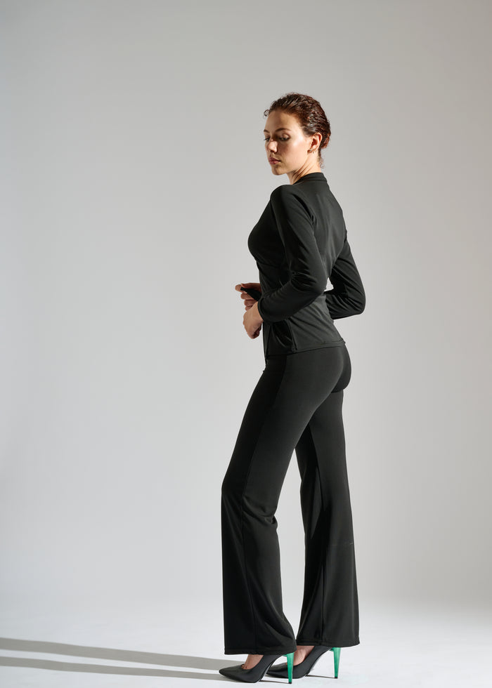 Woman dons long-sleeve black two-piece