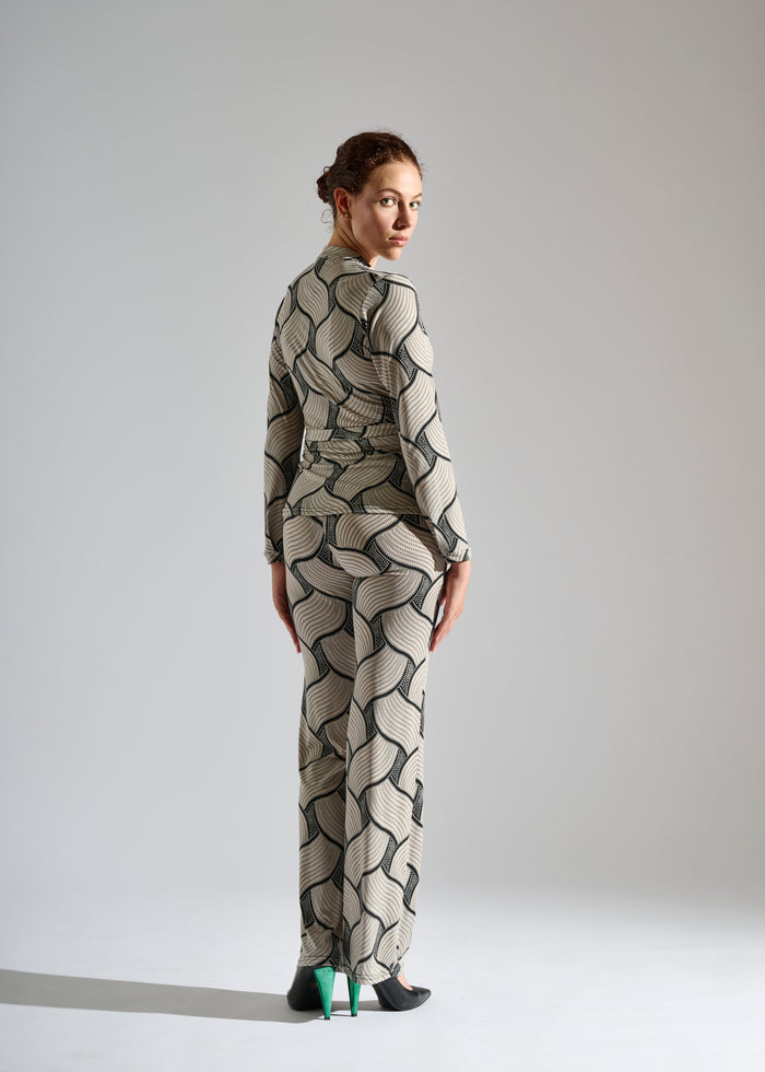 Model dons an Elegance Miss black and white pants set