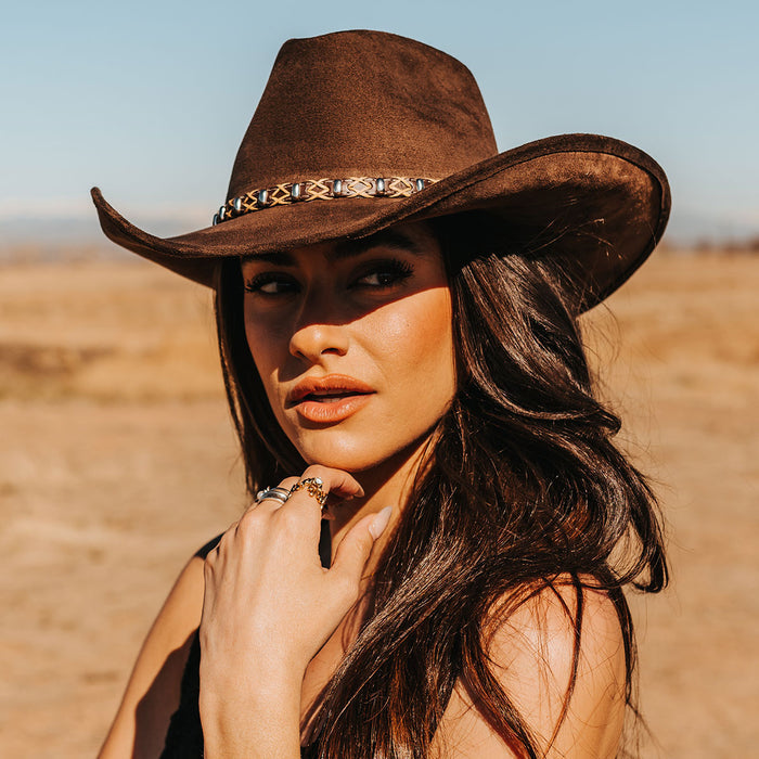 Brown JONES western hat in felt with a wide upturned brim, teardrop crown, and braided leather band accessory.