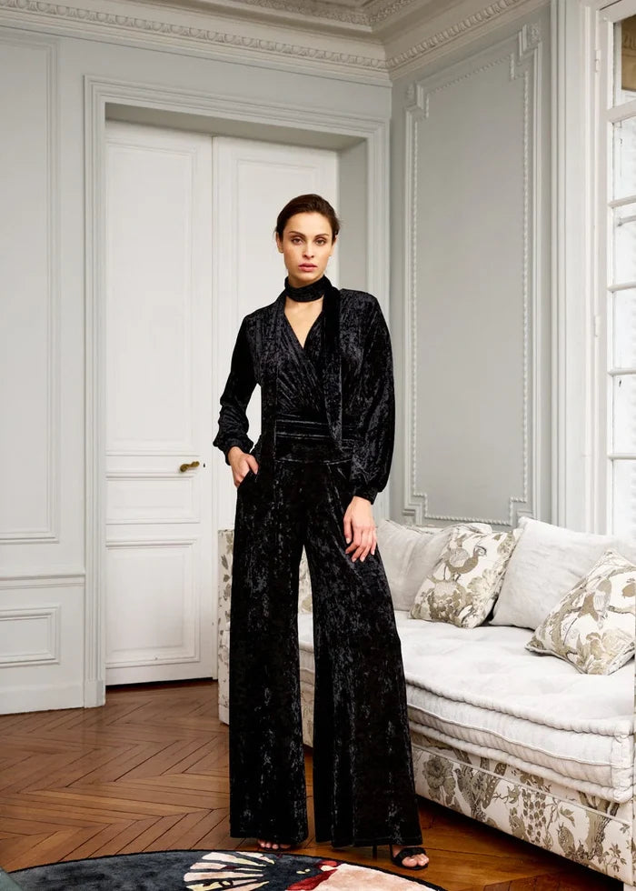 Woman wearing black velvet jumpsuit