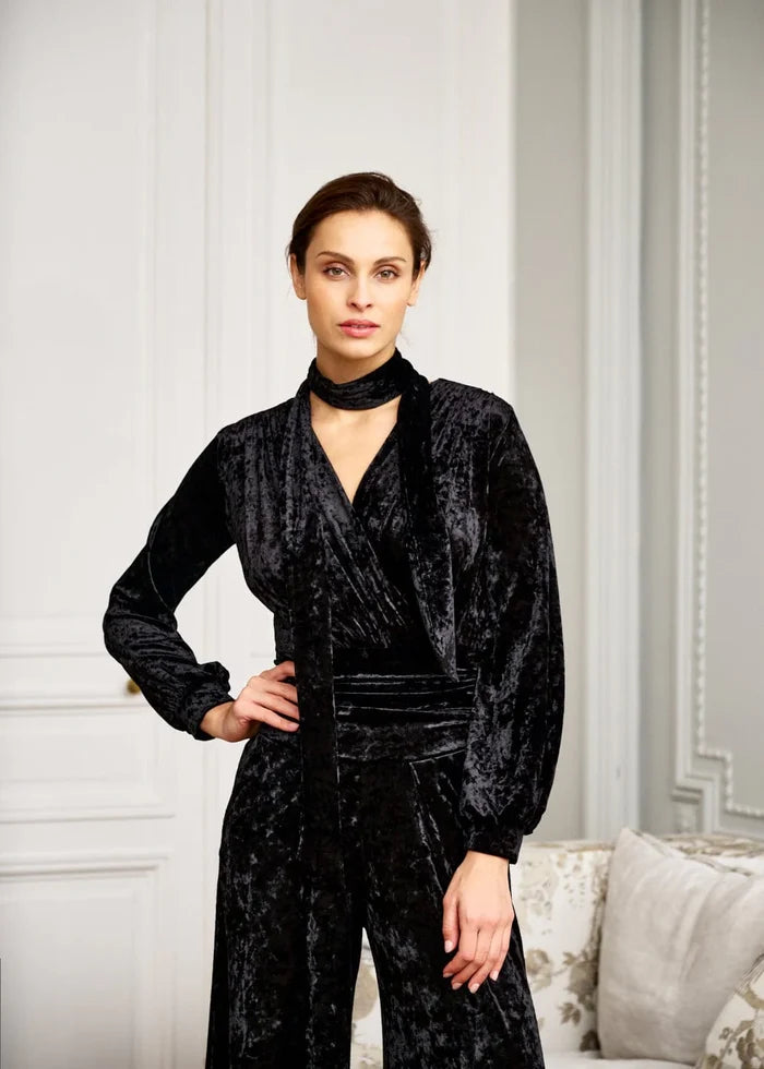Woman models black long-sleeve jumpsuit