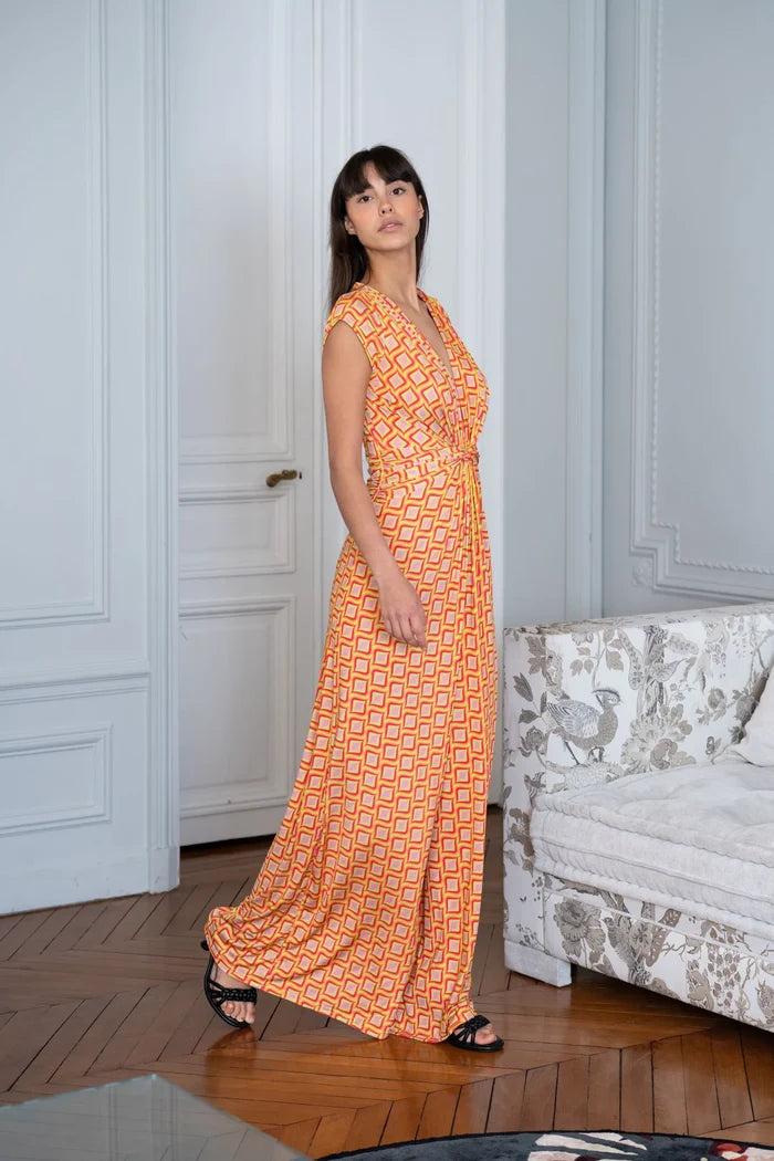 Woman wears a jersey jumpsuit in a Paris apartment